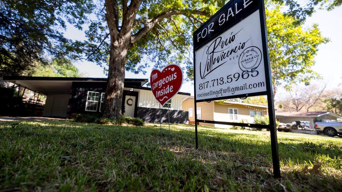A for sale sign in front of a single story home in Fort Worth. There is a large tree in the front yard.