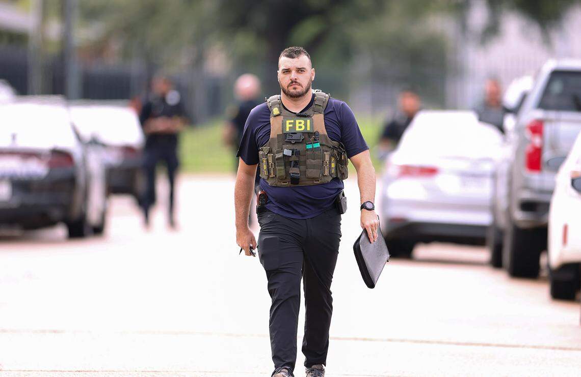 Law enforcement, including the FBI, investigate the scene where a shooting at an Immigration and Customs Enforcement facility occurred in Dallas on Wednesday, Sept. 24, 2025. 