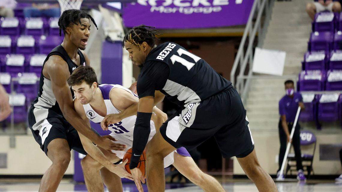 Providence guards David Duke, left, and A.J. Reeves swarm TCU guard Owen Aschieris during a game on Wednesday in Fort Worth. Providence won 79-70.