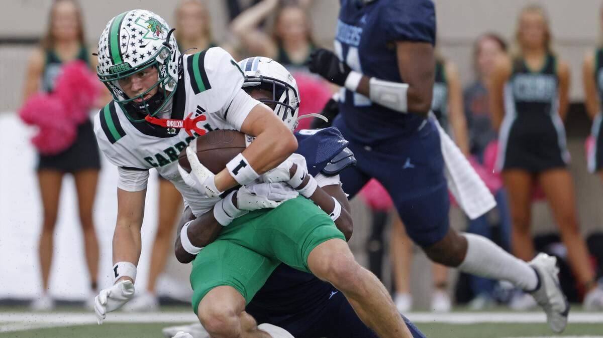 Southlake wide receiver Brock Boyd (1) is brought down by L.D. Bell defensive back Tre'von Taylor (8) during the first half of a UIL football game between Carroll and L.D. Bell at Pennington Field in Bedford, Texas, Friday, October, 24, 2025.