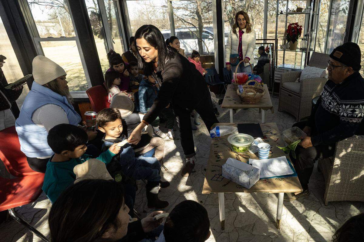 Founder Lizned Larrota hands out snacks to the kids during class at the Curious Farm House in Godley on Wednesday, Dec. 10, 2025. The Curious Farmhouse is a nature-based, bilingual space where children learn farming, nutrition and hands-on skills through gardening.