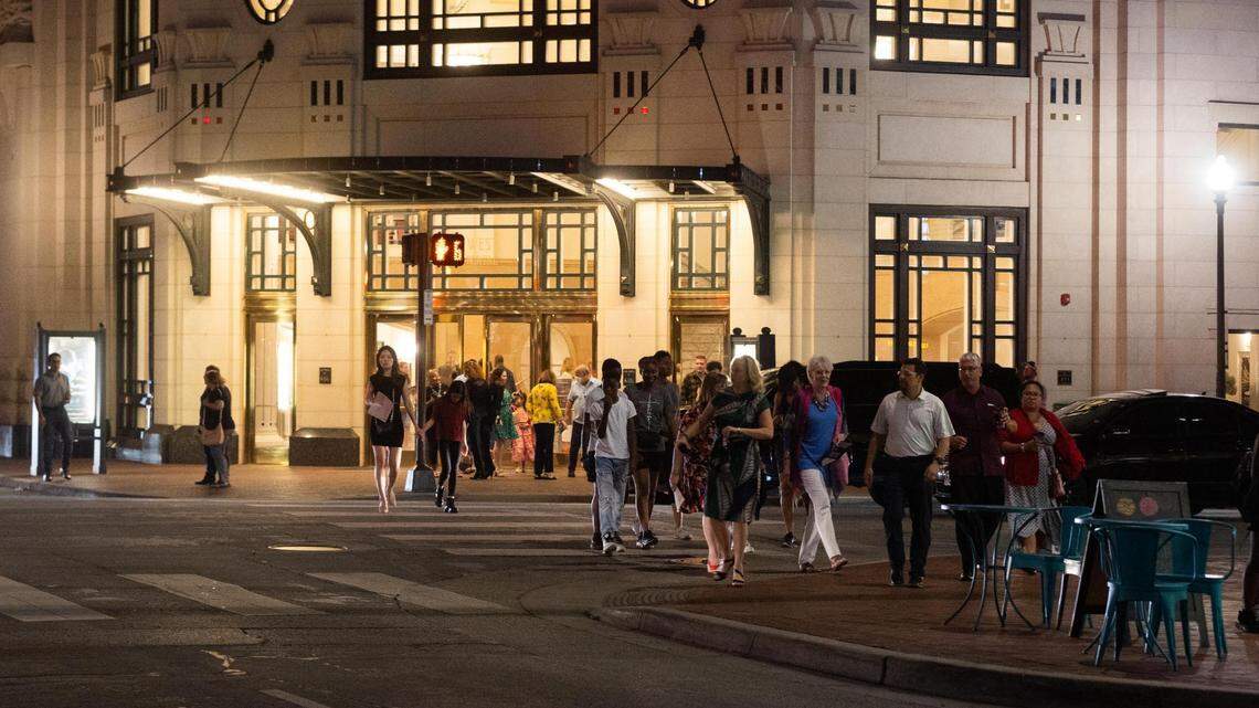 People walk across Commerce Street on Saturday, May 7, 2022, in downtown Fort Worth.