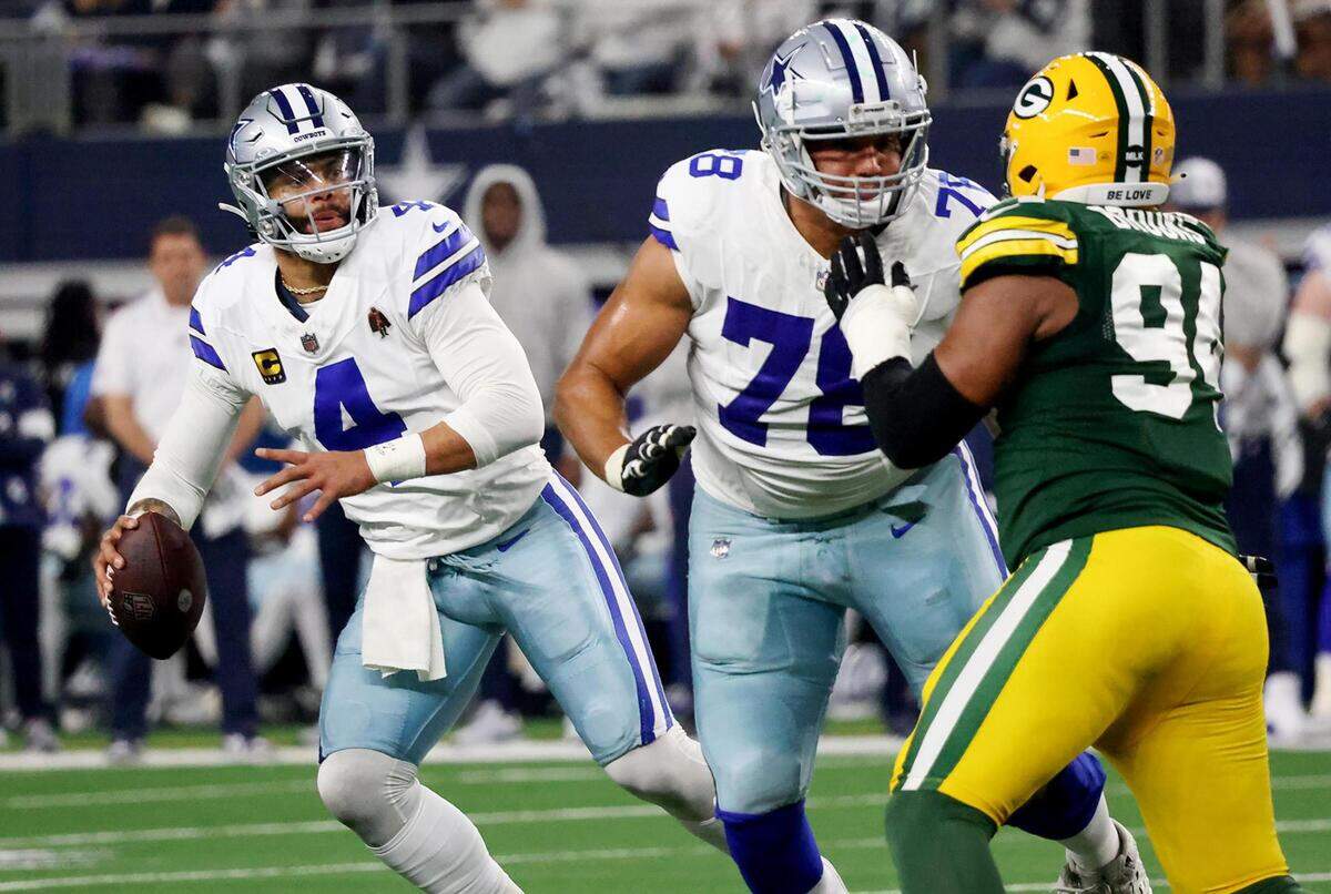 Dallas Cowboys quarterback Dak Prescott looks for a receiver while offensive tackle Terence Steele (78) holds off Green Bay Packers defensive lineman Karl Brooks during the third quarter of the NFC wild-card playoff game against the Green Bay Packers on Sunday, January 14, 2024, at AT&T Stadium in Arlington.