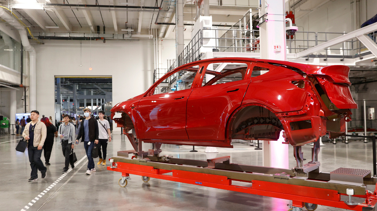 Guests take a tour at the “Cyber Rodeo” grand opening celebration for the new $1.1 billion Tesla Giga Texas manufacturing facility in Austin in April. State leaders are glad to welcome the company but makes it hard to buy Tesla cars in Texas. (Jay Janner /Austin American-Statesman via AP)