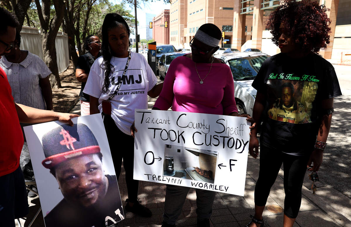 Cassandra Johnson, second from right, and others protest outside the Tarrant County Jail in downtown Fort Worth on July 25, 2022. Johnson’s son, Trelynn Wormley, 23, died while in custody at the Tarrant County Jail.