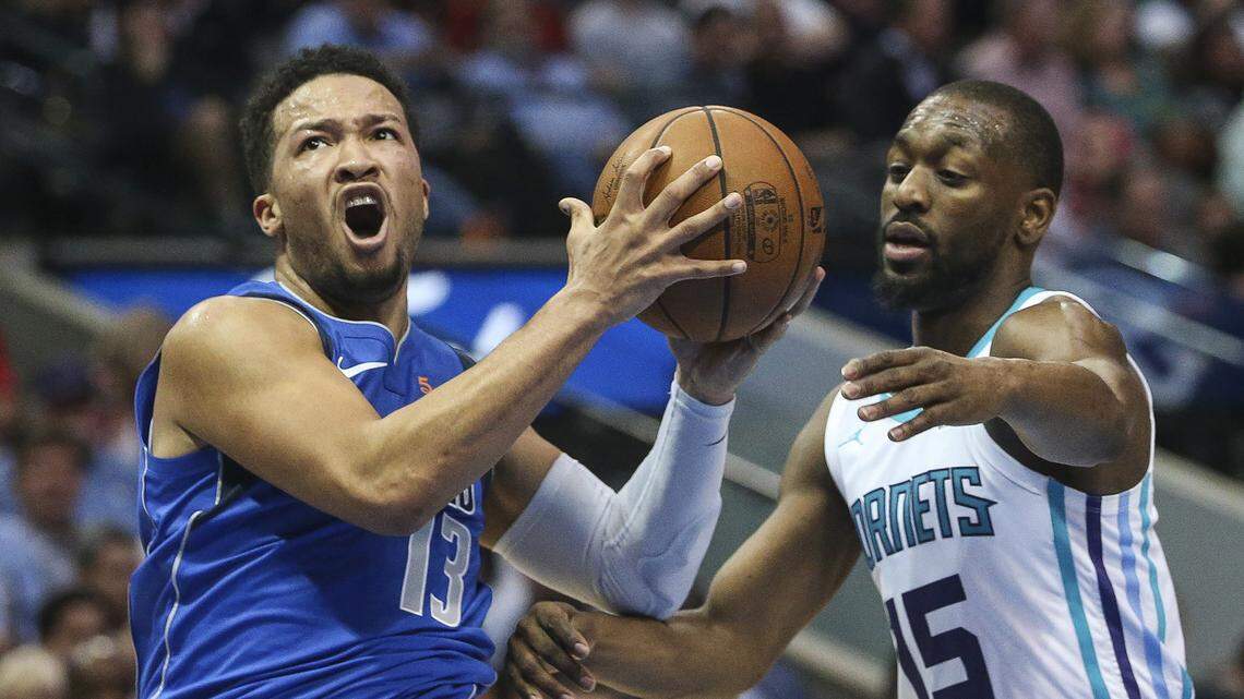 The Dallas Mavericks’ Jalen Brunson (13) goes up for a shot past the Charlotte Hornets’ Kemba Walker (15) during the first half on Wednesday, Feb. 6, 2019, at the American Airlines Center in Dallas. (Ryan Michalesko/Dallas Morning News/TNS)