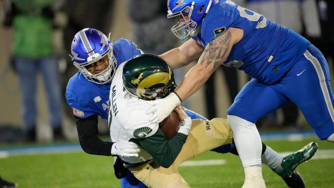 Colorado State quarterback Clay Millen, center, is sacked by Air Force linebacker Vince Sanford, left, and defensive lineman Peyton Zdroik during the second half of an NCAA college football game Saturday, Nov. 19, 2022, at Air Force Academy, Colo.