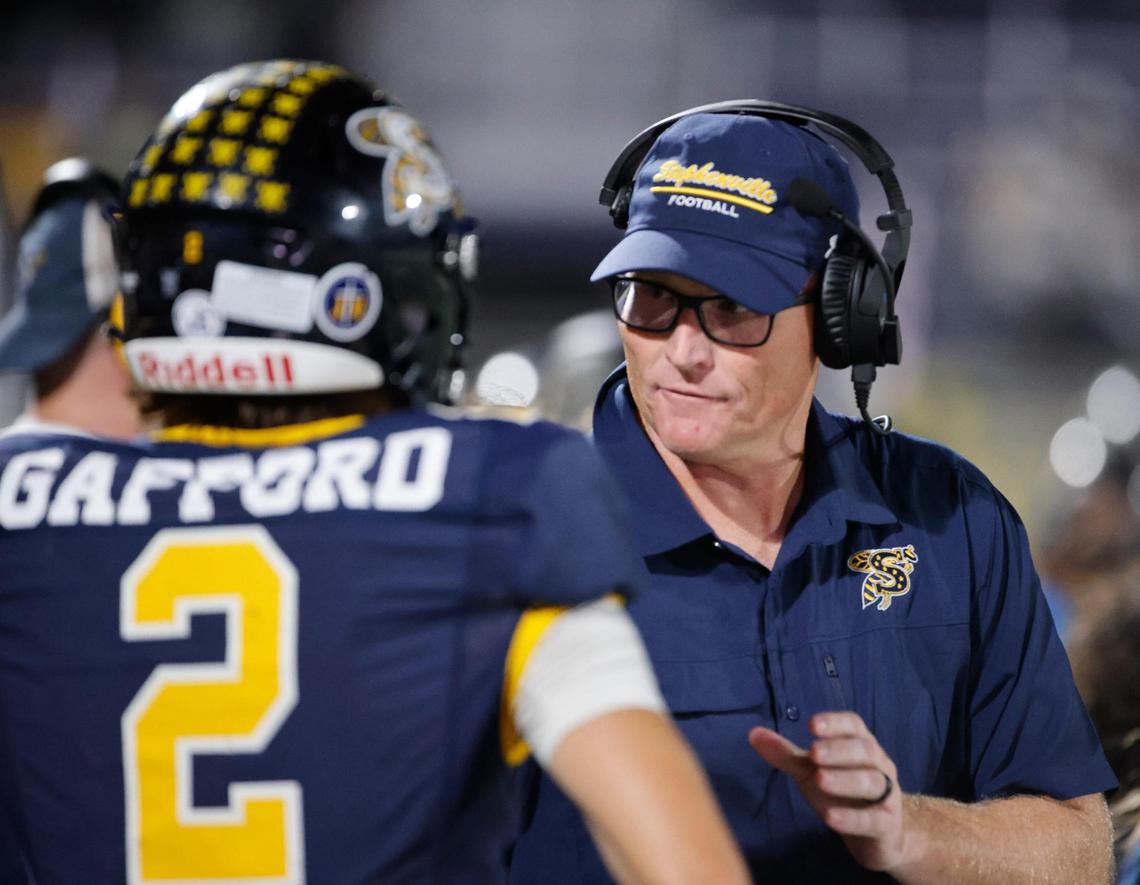 Stephenville head coach Sterling Doty talks to quarterback Ryan Gafford (2) on the sidelines during a UIL District 4-4A D1 football game at Tarleton State Memorial Stadium in Stephenville, Texas, Friday, Nov. 01, 2024.
