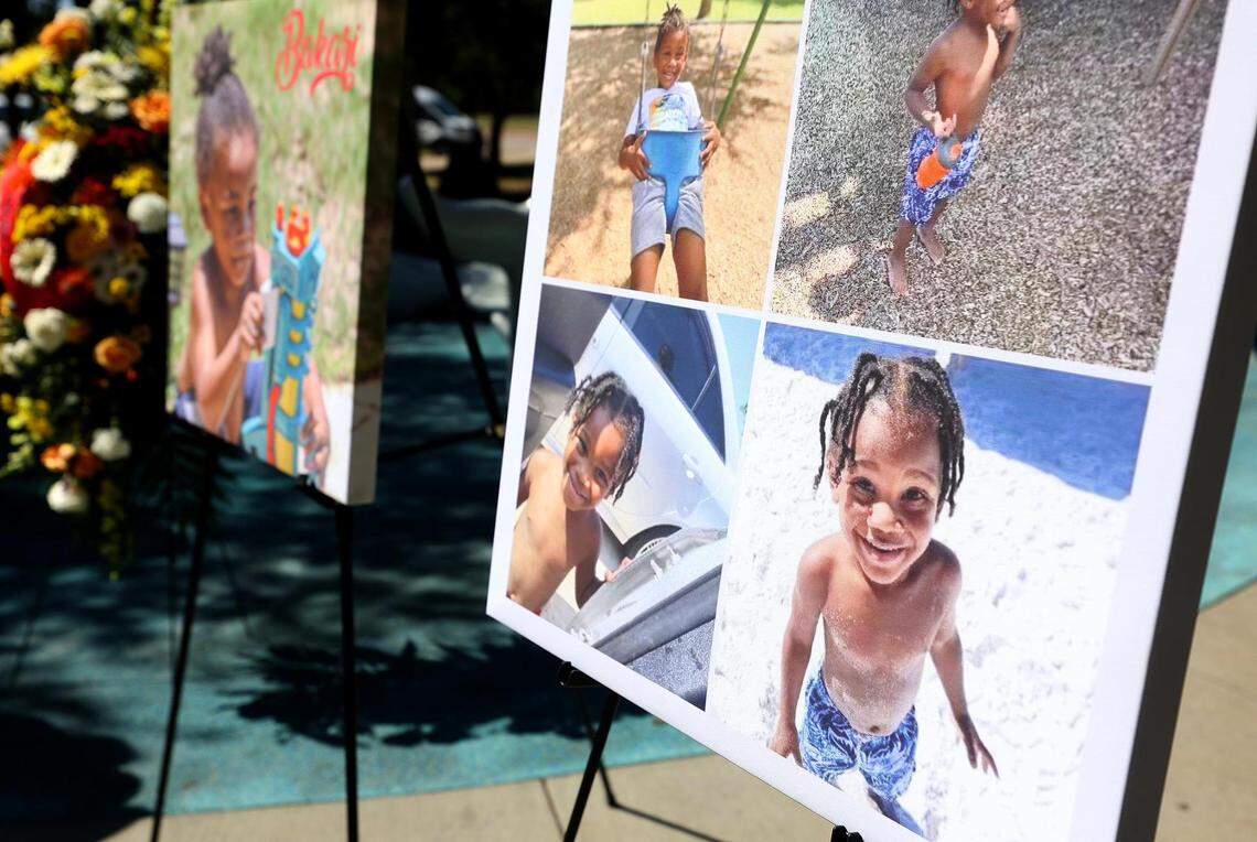 Photos of Bakari Williams, 3, stand beside the Don Misenhimer Park splash pad in Arlington during a press conference on Monday, October 3, 2021. Williams died last month from a brain-eating amoeba he most likely while encountered playing at the splash pad.