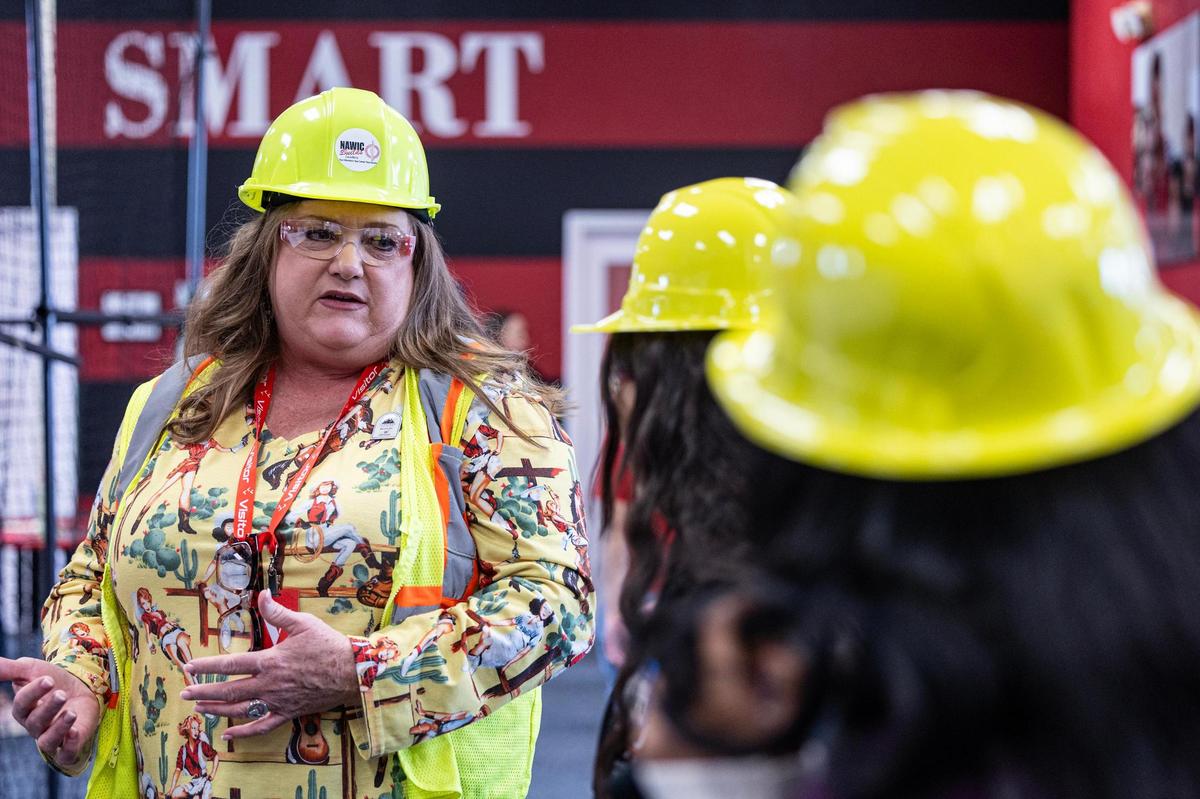 Holly Green, the President of Brett Co Roofing II LLC., speaks with middle school students about a career in construction during the ‘Women in Construction’ event by Girls Inc. of Tarrant County at their headquarters in Fort Worth on Saturday, March 8, 2025.