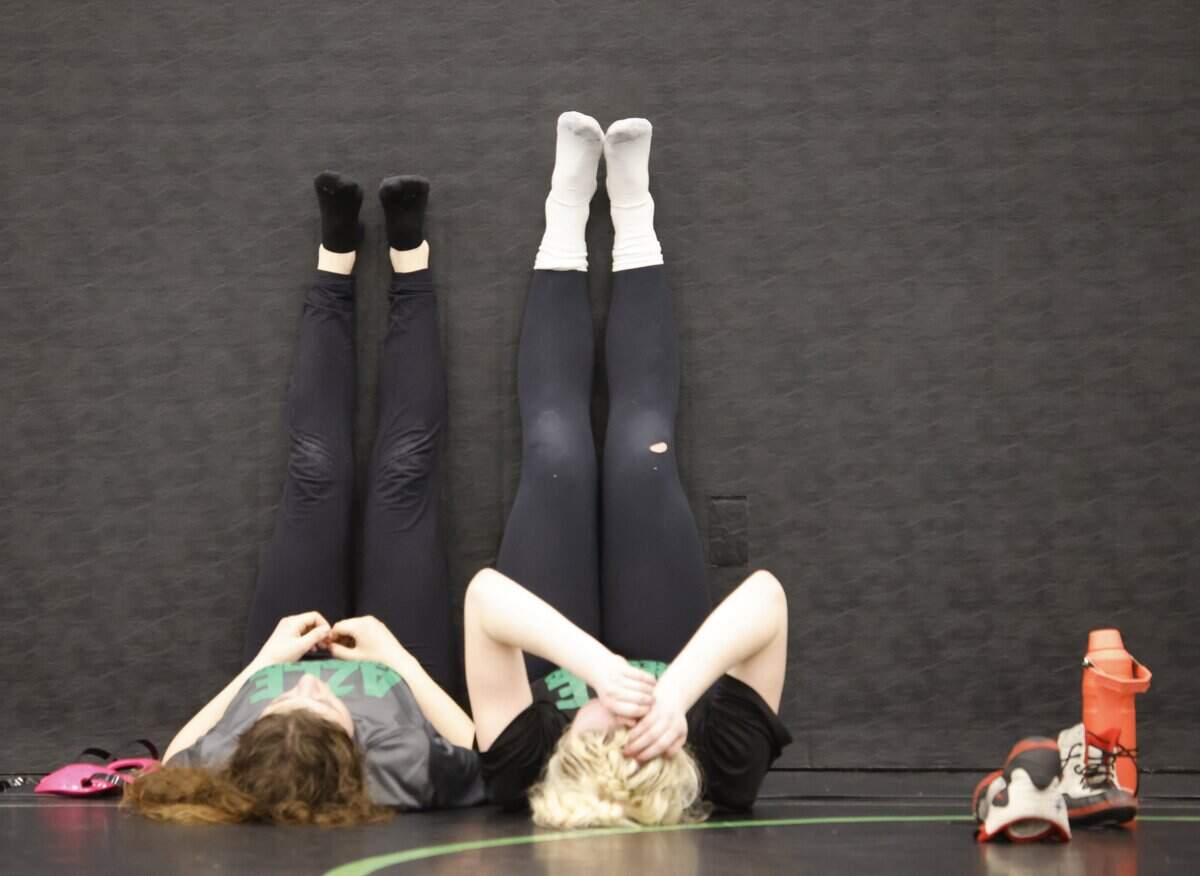 Axle wrestlers Elly Yelle and Sage Mosier relax after one of the final practices before the state championship meet at Azle High School in Azle, Texas, on Friday, Feb. 9, 2026.