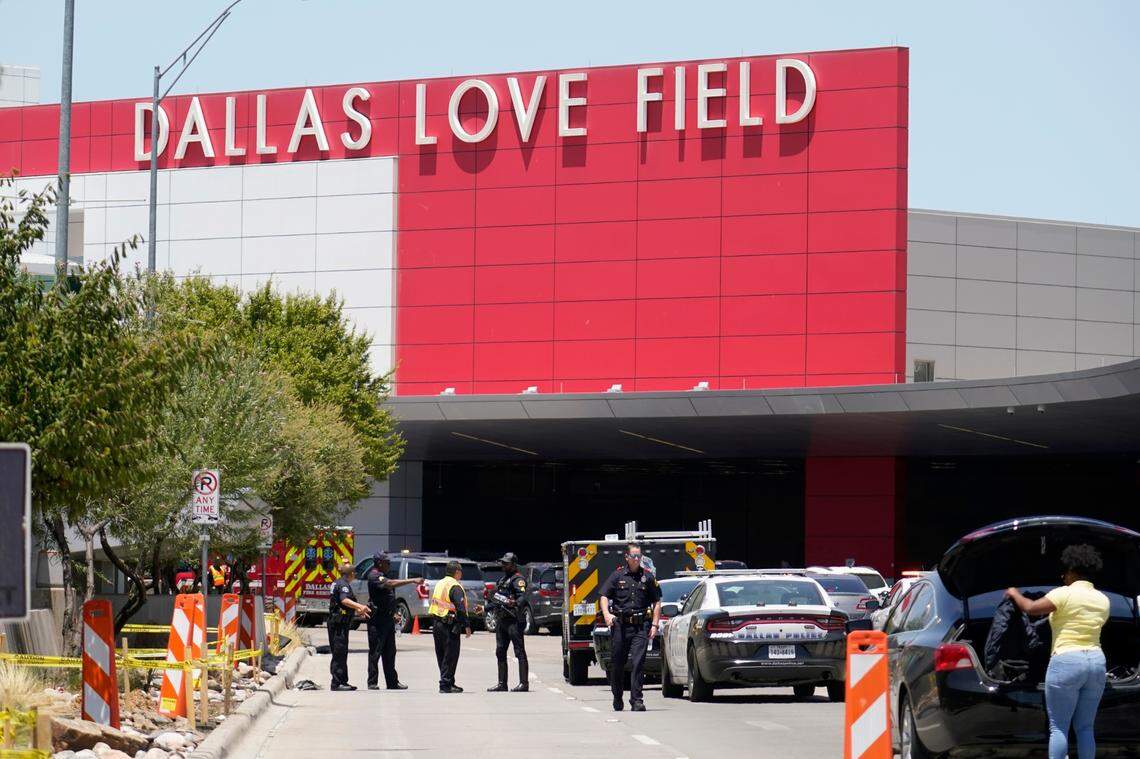 Emergency responders converge near the main entrance at Dallas Love Field in Dallas, Monday, July 25, 2022. A 37-year-old woman fired several gunshots, apparently at the ceiling, inside of Dallas’ Love Field airport on Monday before an officer shot and wounded her, authorities said. (AP Photo/Tony Gutierrez)