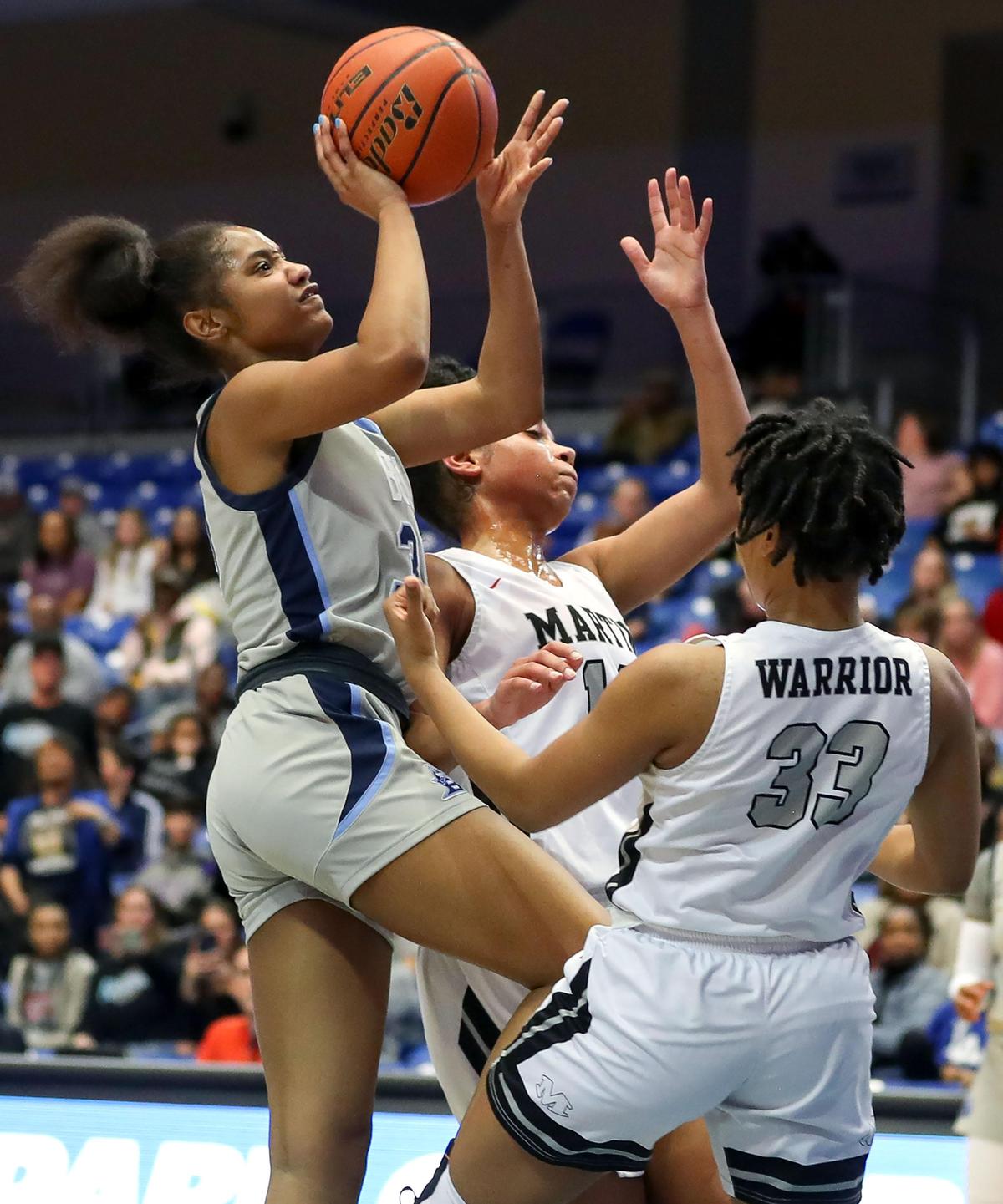 L.D. Bell forward Hallie Rhodes (30) puts up a shot over Arlington Martin guard Ariana Bracey (33) during the first half of the Girls Regional Quarterfinal Playoff basketball game, Tuesday, February 25, 2020 at the College Park Center on the UTA campus in Arlington, Texas.