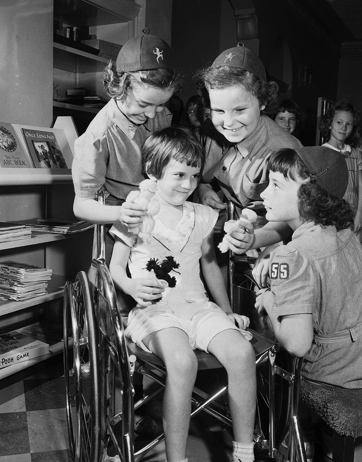 Oct. 21, 1953: Brownies from Troop 55 present the dolls they made to patients like Judy Dwyer, daughter of H.L. Dwyer of Cleburne, at W.I. Cook Memorial Hospital Center for Children. Among the 11 Brownies who visited the hospital were, left to right, Glenda Holder, 556 Conner; Reta Ruby, 2559 Camilla, and Dayna Dyer, 1101 Arch.