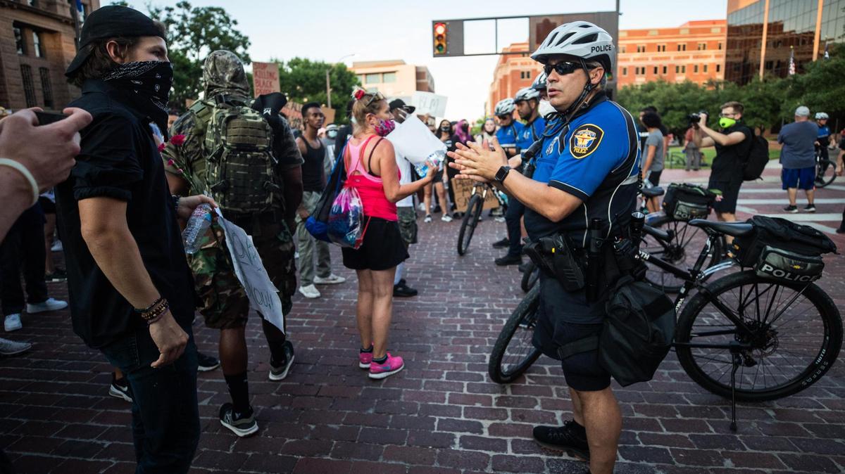 Police officers create a line around protesters in front of the Tarrant County Courthouse Tuesday, June 2, 2020, in Fort Worth.