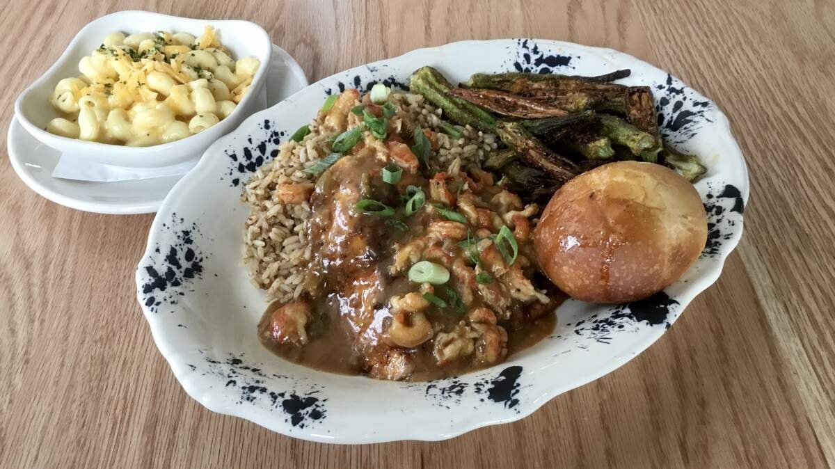 A “tricky’ blackened redfish with etouffee, dirty rice and fried okra at Tricky Fish in Waterside.