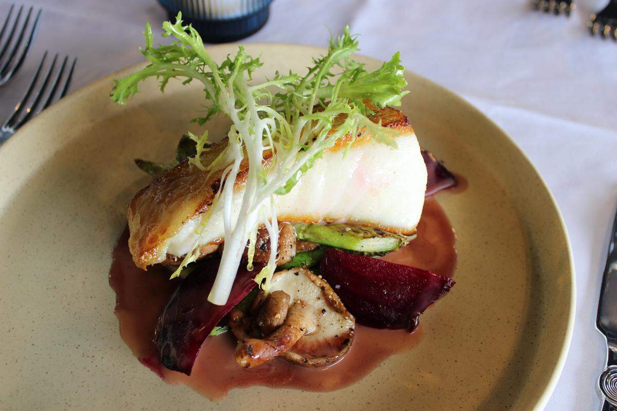 Chilean sea bass at Theodore’s Steak and Seafood is served with asparagus, beets and mushrooms in a port wine sauce.