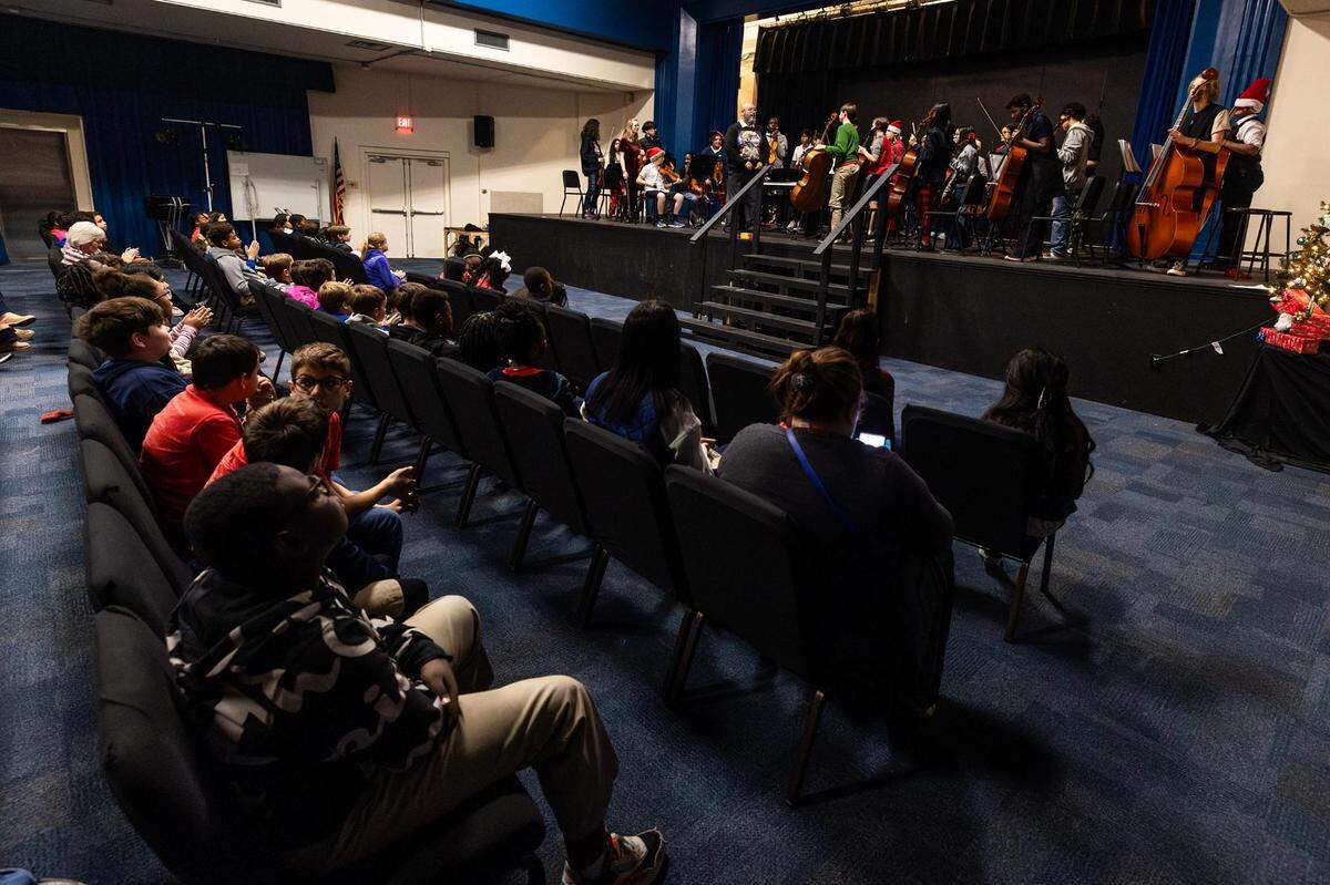 Orchestra director Julio Montañez directs his orchestra students for a concert during the Ridglea Elementary School visit at Applied Learning Academy in Fort Worth on Thursday.