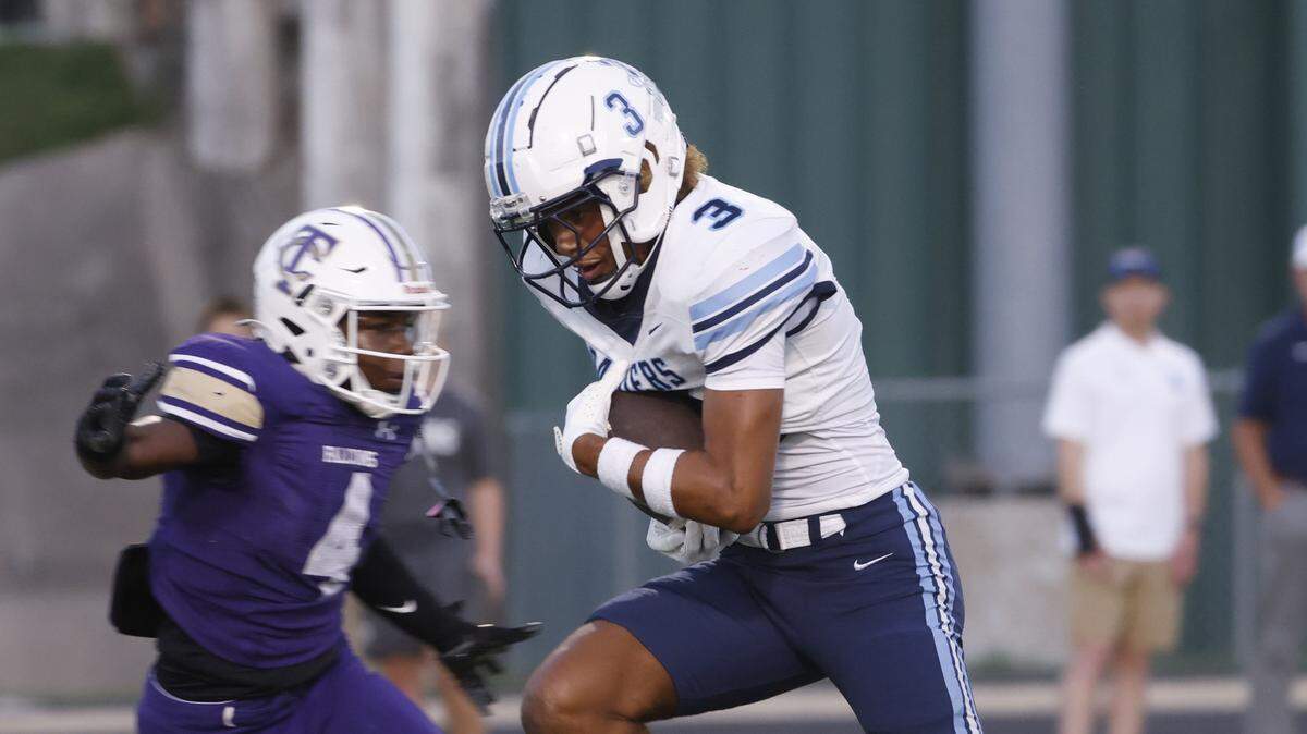 L.D. Bell wide receiver Braelon Solomon (3) escapes the grasp of Tiber Creek defensive back Andrew Bridges for a touchdown during the first half of a UIL football game between L.D. Bell and Timber Creek at Keller ISD Athletic Complex in Keller, Texas, Thursday, Sept. 11, 2025.