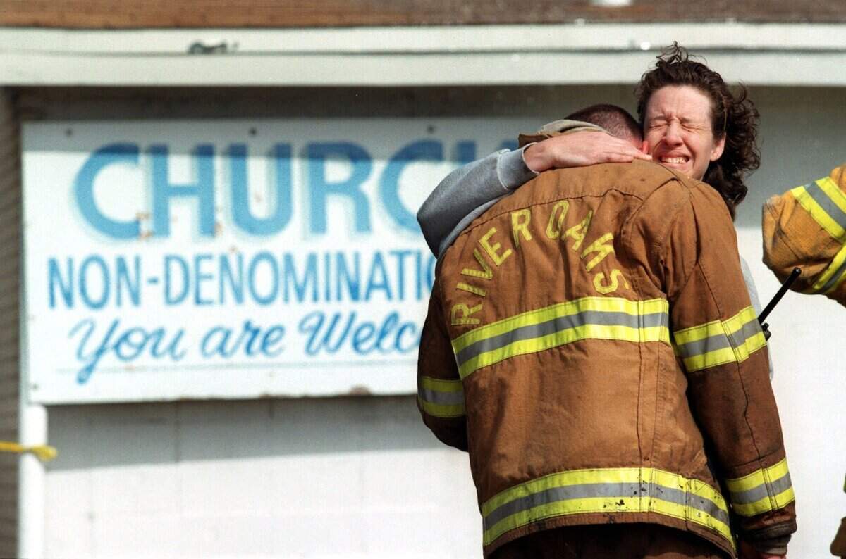 Lt. Heidi Burks of the Westworth Village Fire Department, hugs an unidentified River Oaks firefighter after learning of the deaths of three firemen at a fire at Precious Faith Temple in Lake Worth, Texas, Monday Feb. 15, 1999. The three firemen died when the roof collapsed while fighting the blaze. (AP Photo/Fort Worth Star-Telegram/Jill Johnson)