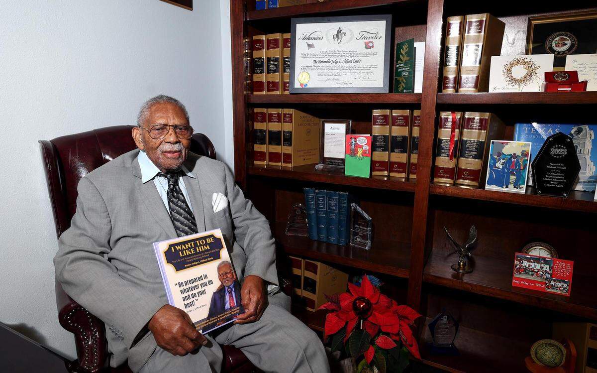 Judge L. Clifford Davis, 99, holds a book, released by local attorney Bobbie Edmonds, about this life and legacy. Davis opened one of the first African-American law offices in Tarrant County and was one of the first Black district judges appointed in Tarrant County.