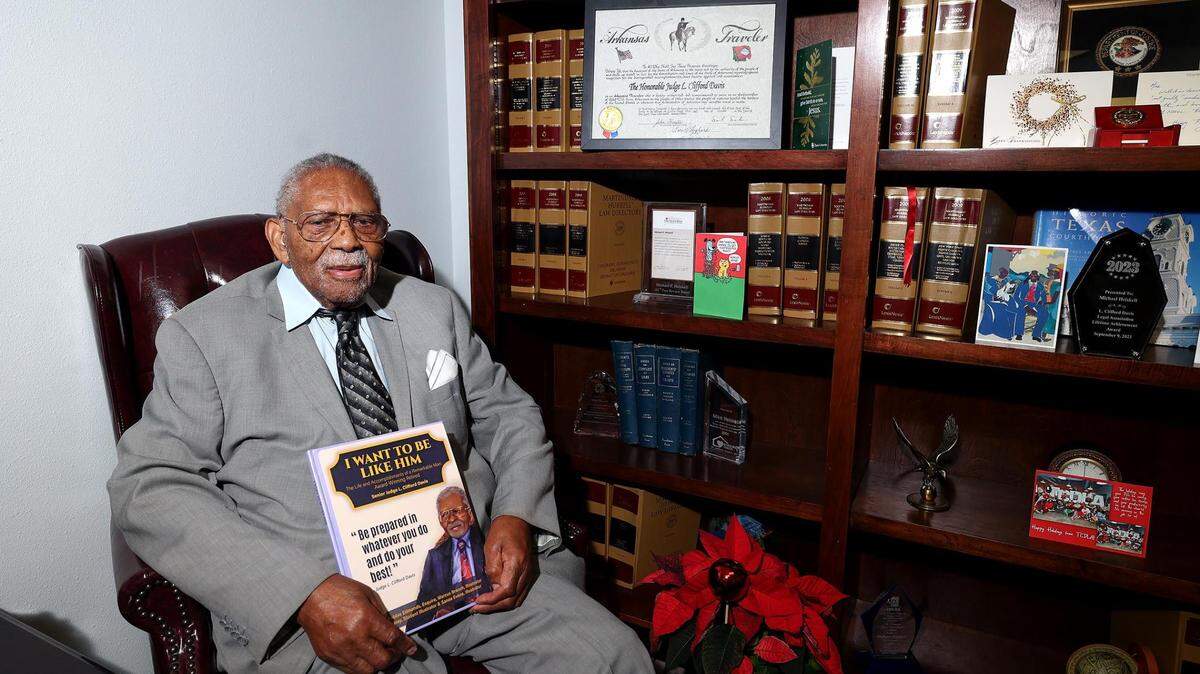 Judge L. Clifford Davis holds a book, released by local attorney Bobbie Edmonds, about his life and legacy. Davis opened one of the first African-American law offices in Tarrant County and was one of the first Black district judges appointed in Tarrant County. He died Saturday at the age of 100.