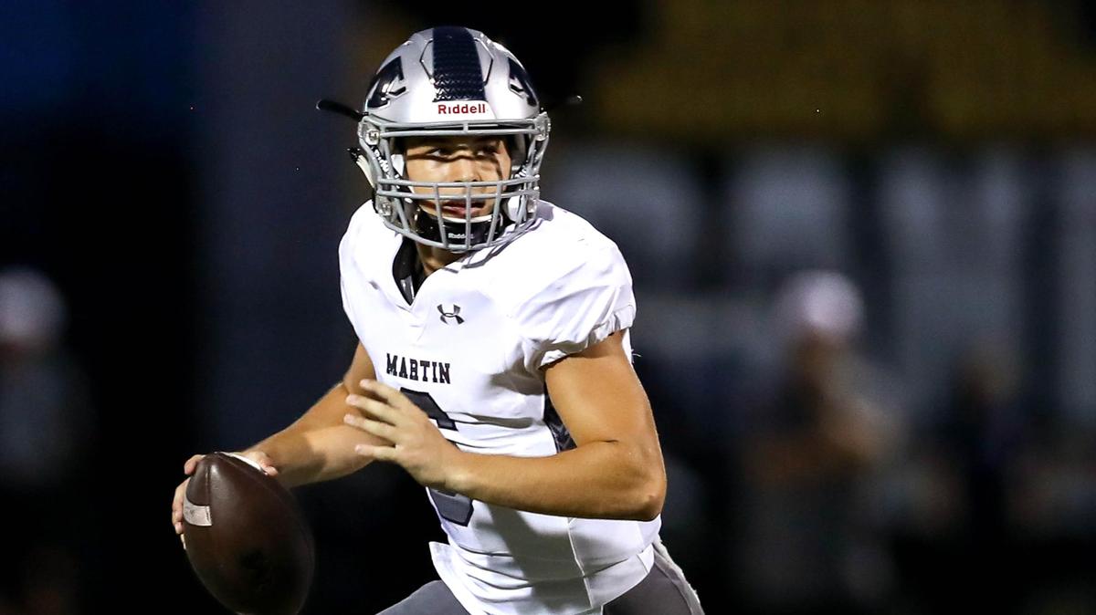 Arlington Martin quarterback Zach Mundell rolls out to pass against Rockwall during the first half, Friday night, September 20, 2019 played at Wilkerson-Sanders Stadium in Rockwall, TX