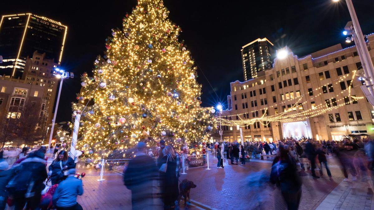Families gather around the Christmas Tree at Sundance Square in Fort Worth on Saturday, Dec. 16, 2023.