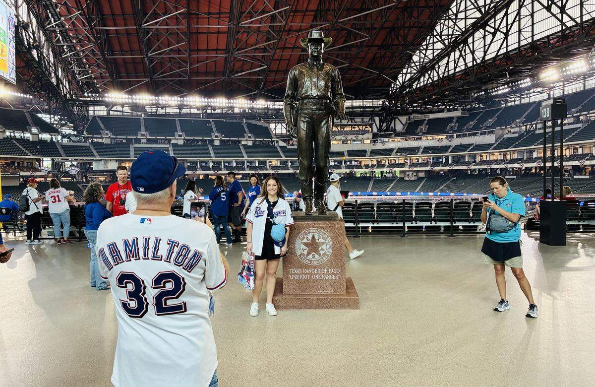 At the home opener for the Texas Rangers on Friday at Globe Life Field in Arlington, fans posed for pictures in front of the new statue of a Texas Rangers lawman.