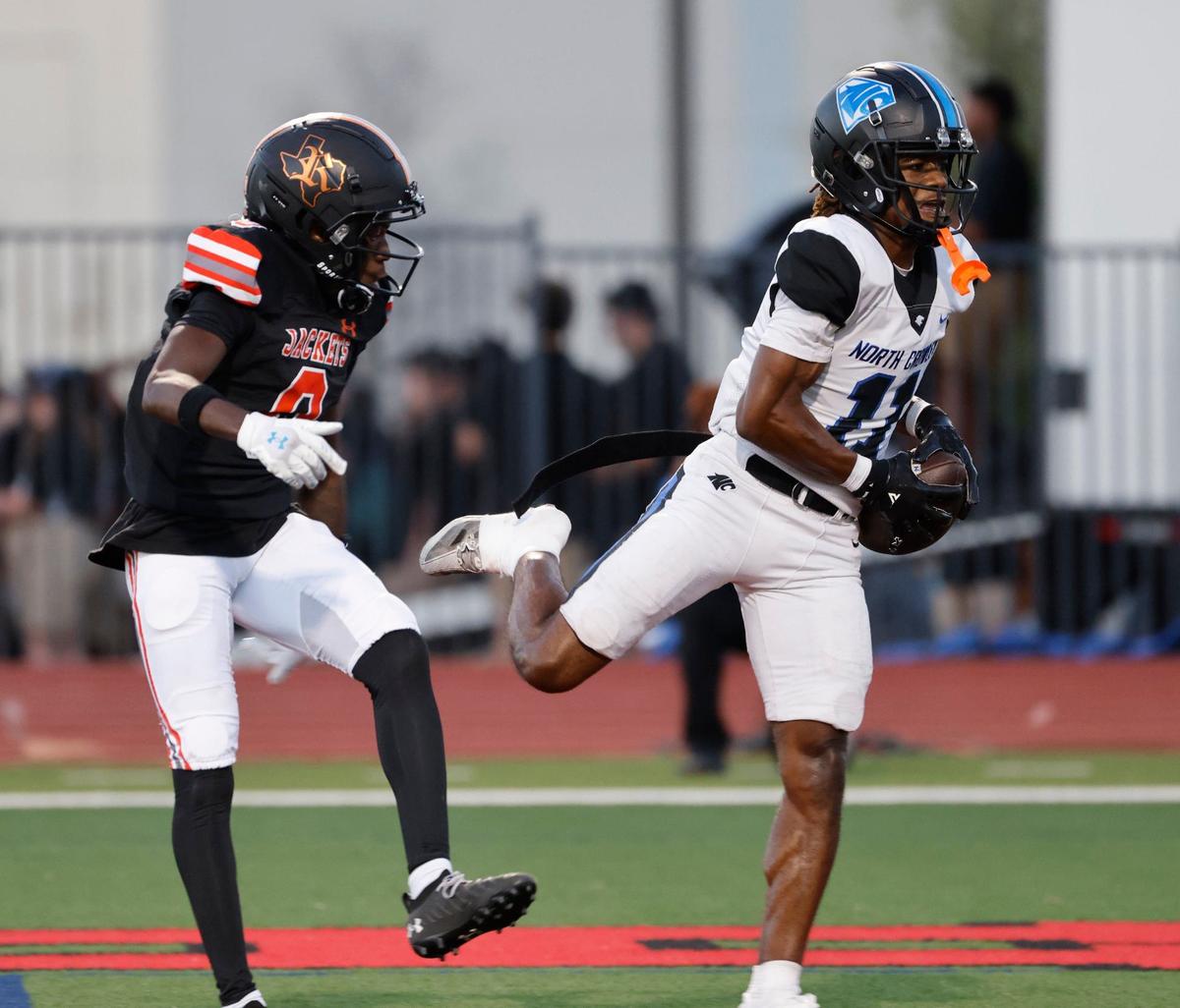 North Crowley wide receiver Cam Hunter (11) grabs a touchdown catch in front of Rockwall cornerback Eric Gabriel (0) during a UIL 6A Conference football game at Wilkerson-Sanders Memorial Stadium in Rockwall Texas, Thursday, Sept. 19, 2024.