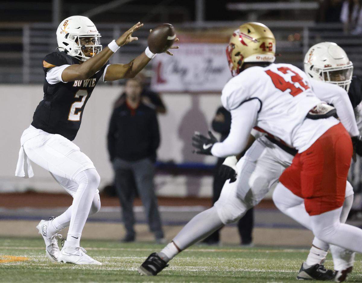 Bowie quarterback Jayden Bibbs (2) secures a high snap during the first half of a UIL football game between South Grand Prairie and Arlington Bowie at UTA Maverick Stadium in Arlington, Texas, Thursday Nov. 06, 2025.