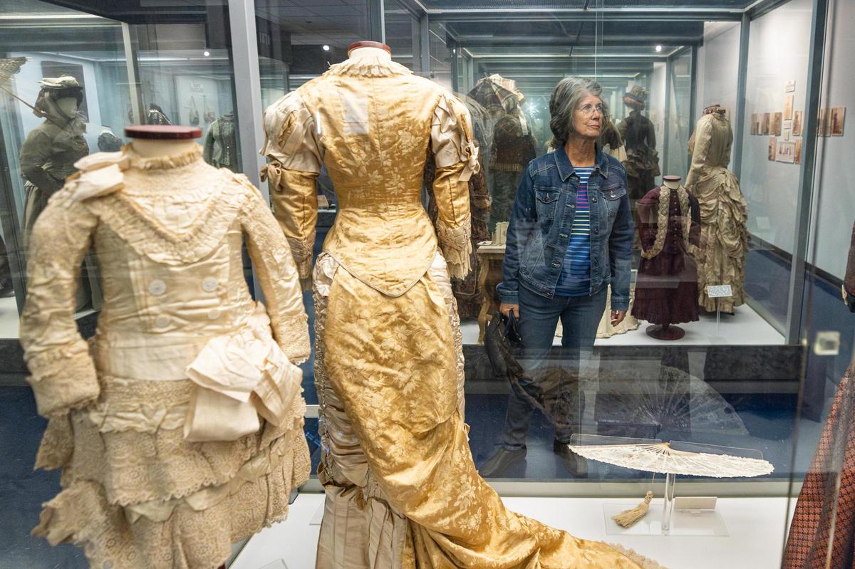 Patti Crummel looks at different types of dresses worn in the 1800’s on display at the Texas Civil War Museum.