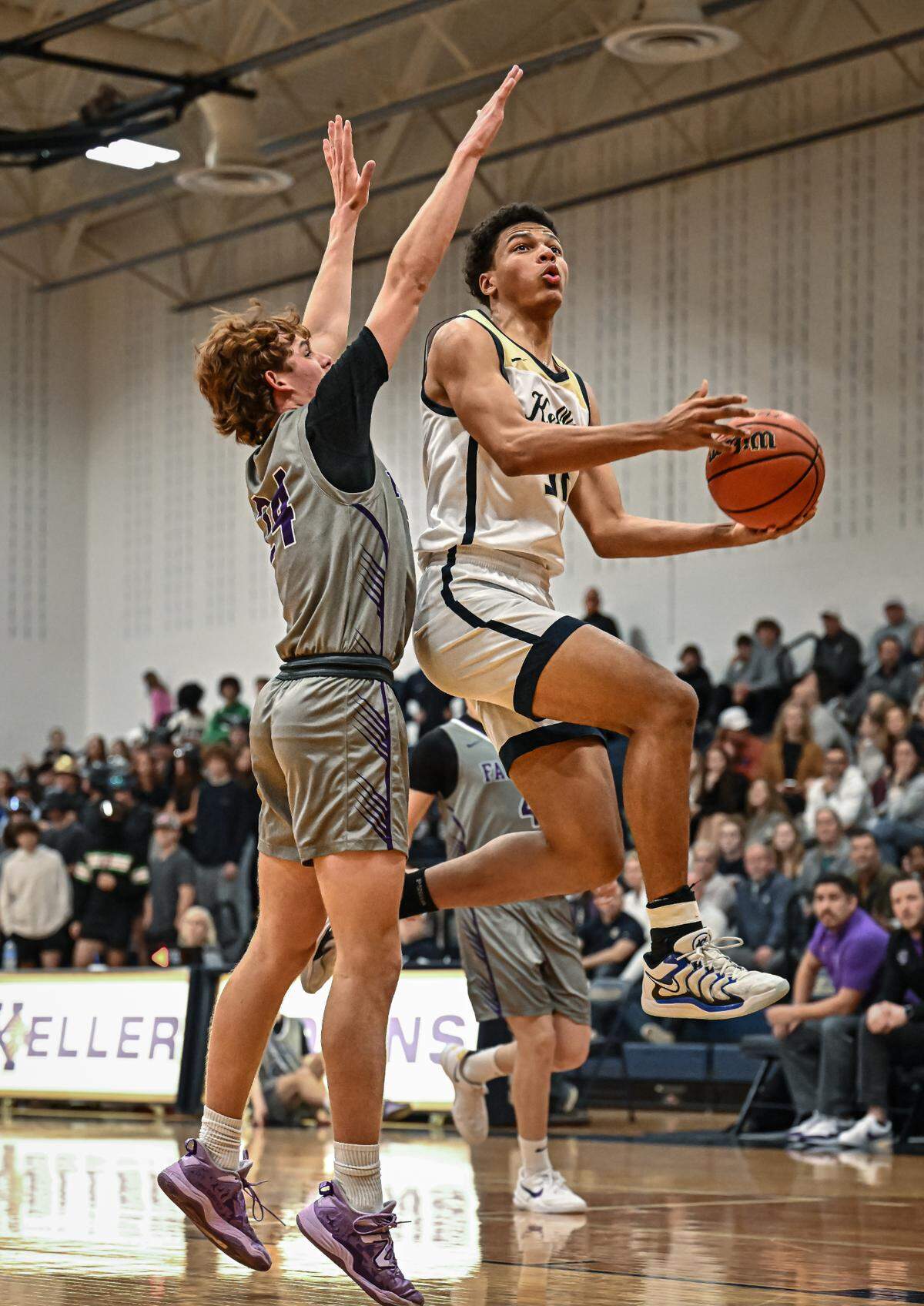 Keller’s Seth Turnbull, right, goes in for a lay up against Keller Timber Creek in a District 4-6A boys basketball game on Tuesday, January 28, 2025 at Keller High School in Keller, Texas.