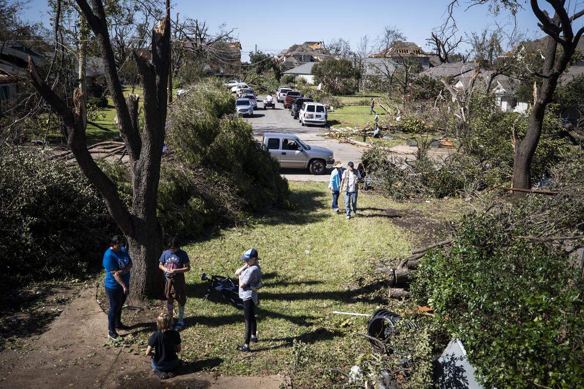 Residents assess damage to homes after a tornado Monday, Oct. 21, 2019, in Northwest Dallas.