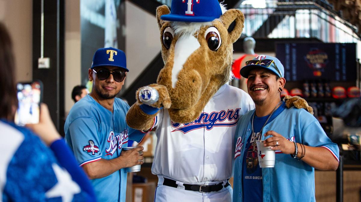 Woody Rodarte, left, and Henry Rodarte, right, takes a photo with the Texas Rangers mascot during the Home Run Derby on Monday, July 15 at Globe Life Field in Arlington. Both brothers are cheering for right fielder José Adolis García Arrieta, nicknamed “El Bombi” during the derby.