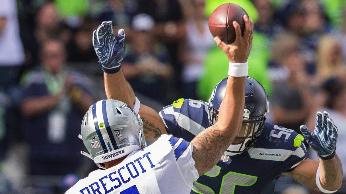 Seahawks linebacker Mychal Kendricks flies toward Cowboys quarterback Dak Prescott. causing an incomplete pass in Seattle’s 24-13 win Sunday at Century Link Field.