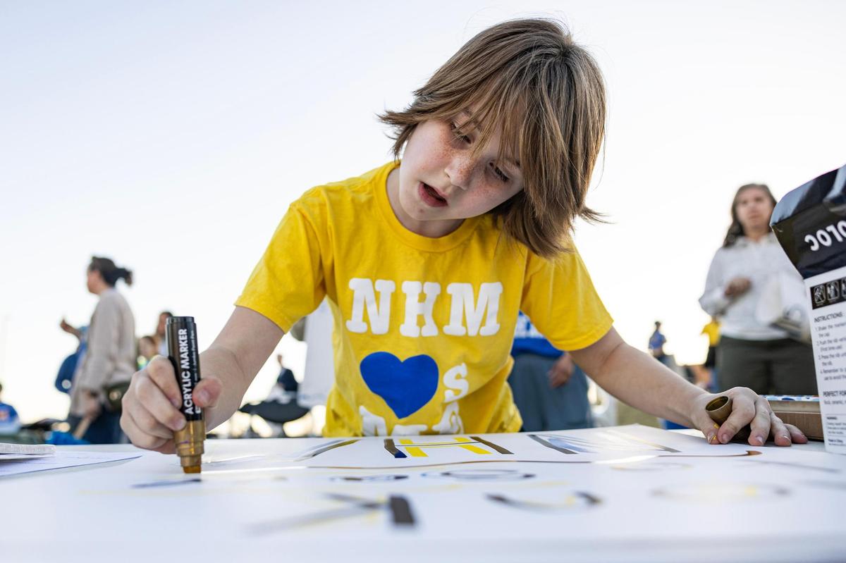 North Hi Mount Elementary fifth-grade student Bo Elverum, 10, draws a sign in support of his school during a rally prior to the third Fort Worth ISD community meeting to discuss potential school closures at Benbrook Middle-High School on Thursday, Feb. 27.