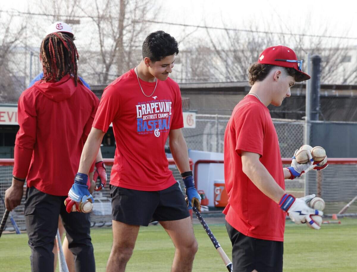 Zach Goldstein and Gianni Corral gather balls for batting practice during Grapevine Mustang baseball practice at Grapevine High School in Grapevine, Texas, Tuesday Feb. 17, 2026.
