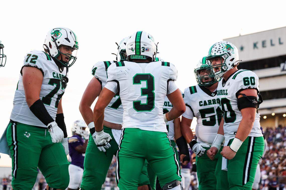 Southlake Carroll offensive linemen celebrate with running back Davis Penn (3) after a touchdown against Keller Timber Creek on Sept. 25 at Keller ISD Stadium. The Dragons are seeking their first state title since 2011.