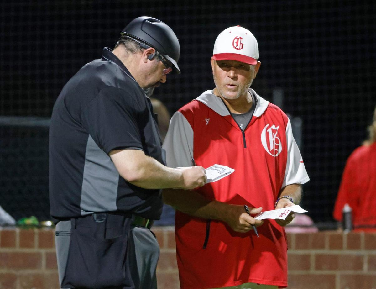 Grapevine head coach Jimmy Webster informs the home plate umpire of player subs during a UIL baseball game at Grapevine Mustang Field in Grapevine, Texas, Thursday, Apr. 17, 2025.