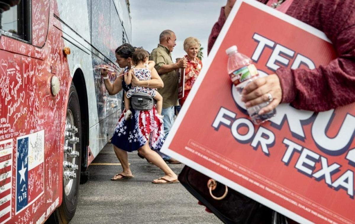 Krystal Devos holds daughter Eliana while she signs U.S. Sen. Ted Cruz’s campaign bus during a stop at S & J Bakery on Tuesday, Oct. 22, 2024, in Corpus Christi, Texas.