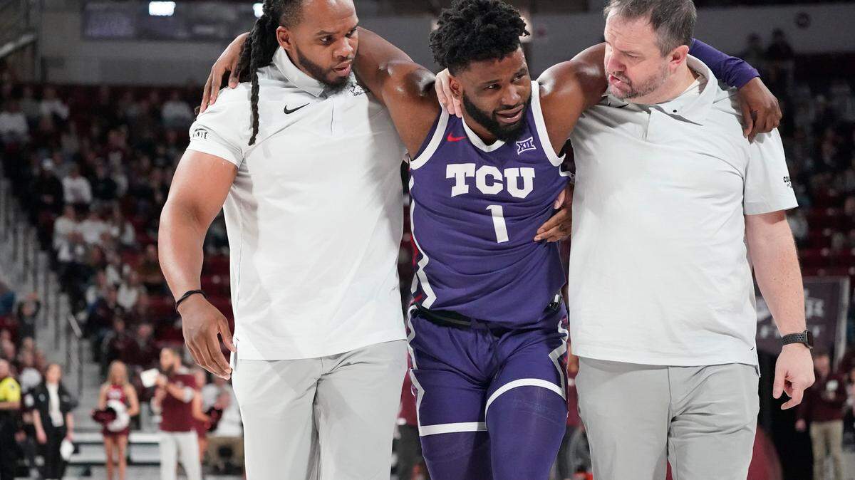 TCU trainers assist guard Mike Miles Jr. (1) after he was injured during the team’s NCAA college basketball game against Mississippi State in Starkville, Miss., on Saturday.