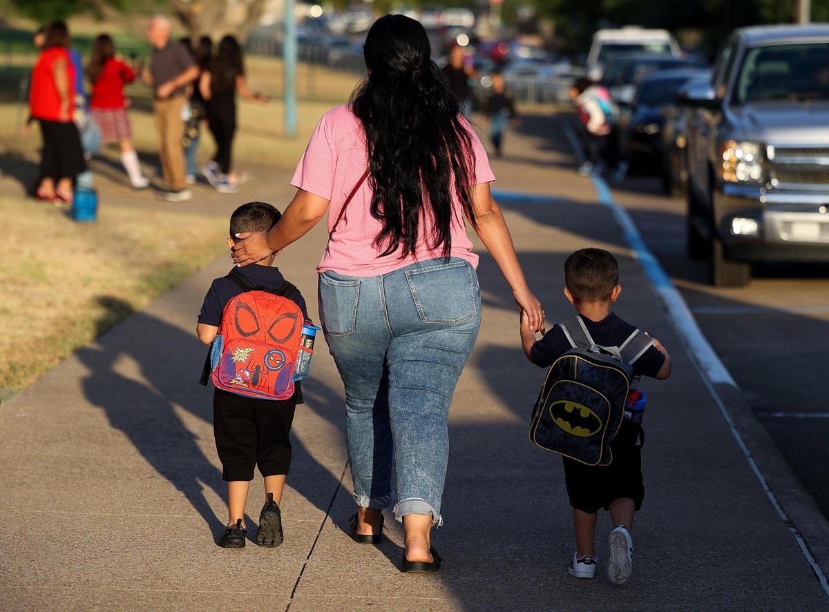 Parents and children arrive at T.A. Sims Elementary School for the first day of school on Monday, August 14, 2023, in Fort Worth.