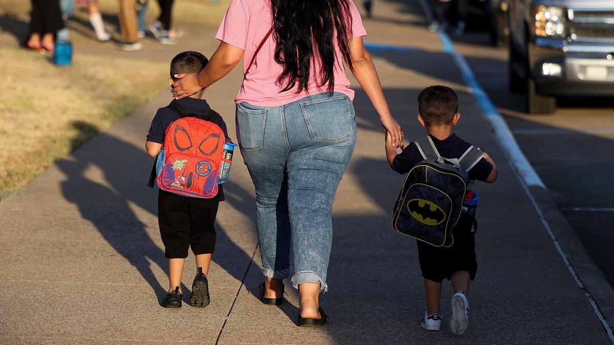 Parents and children arrive at T.A. Sims Elementary School for the first day of school on Aug. 14, 2023, in Fort Worth.