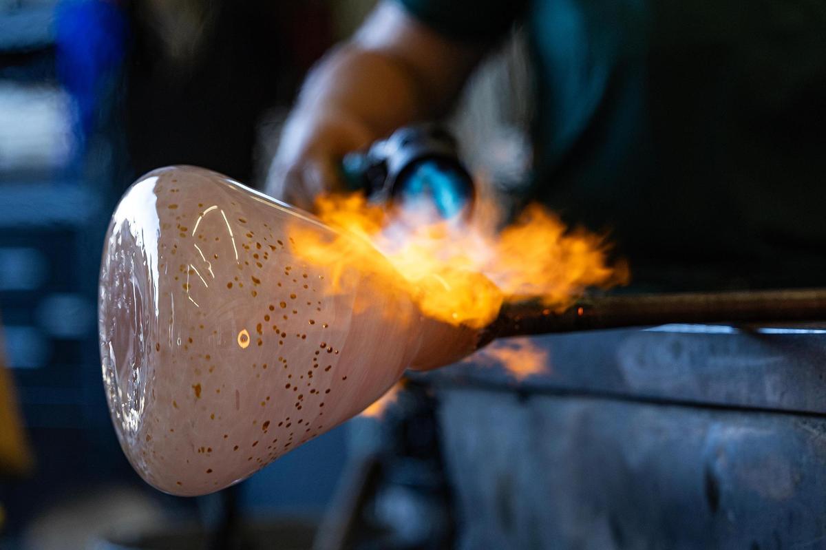 Isabella Raquel Posca, a University of Texas Arlington Glass student, works on molding the molten glass into an open vase during the Arts Goggle event on Magnolia Avenue in Fort Worth on Saturday, Oct. 19, 2024.