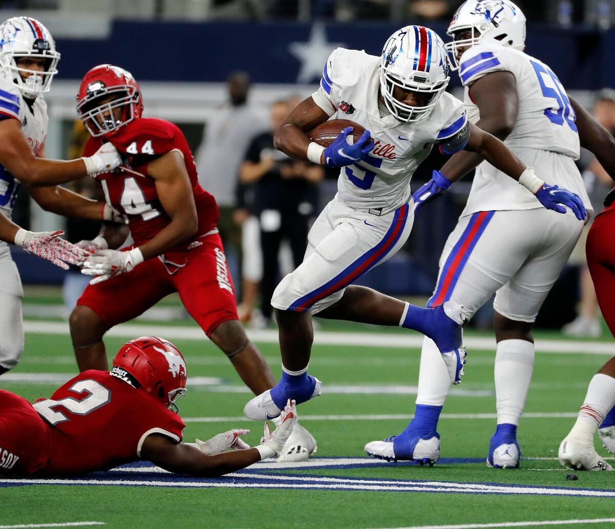 Duncanville running back Malachi Medlock (5) avoids a shoestring tackle by North Shore defensive back Caleb Flagg (2) during a high school 6A division 1 state championship football game at AT&T Stadium in Arlington, Texas, Saturday, Dec. 18, 2021. North Shore defeated Duncanville 17-10. (Special to the Star-Telegram Bob Booth)