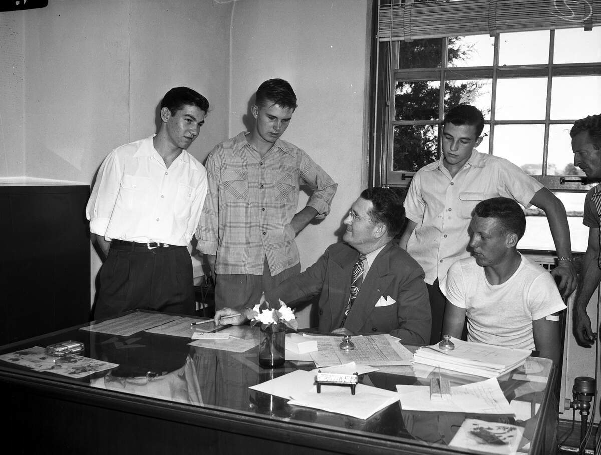 Sept. 10, 1945: Students throughout Fort Worth are preparing for the opening day of the 1945-46 school year. Principal Elden B. Busby of Arlington Heights High, is conferring with a group of new students entering the high school. The students, left to right, are Dean Hatch of Azle, Jim Cornish of Houston, Conrad Johnson of San Antonio, and Gene Fensky of Compton, Calif.