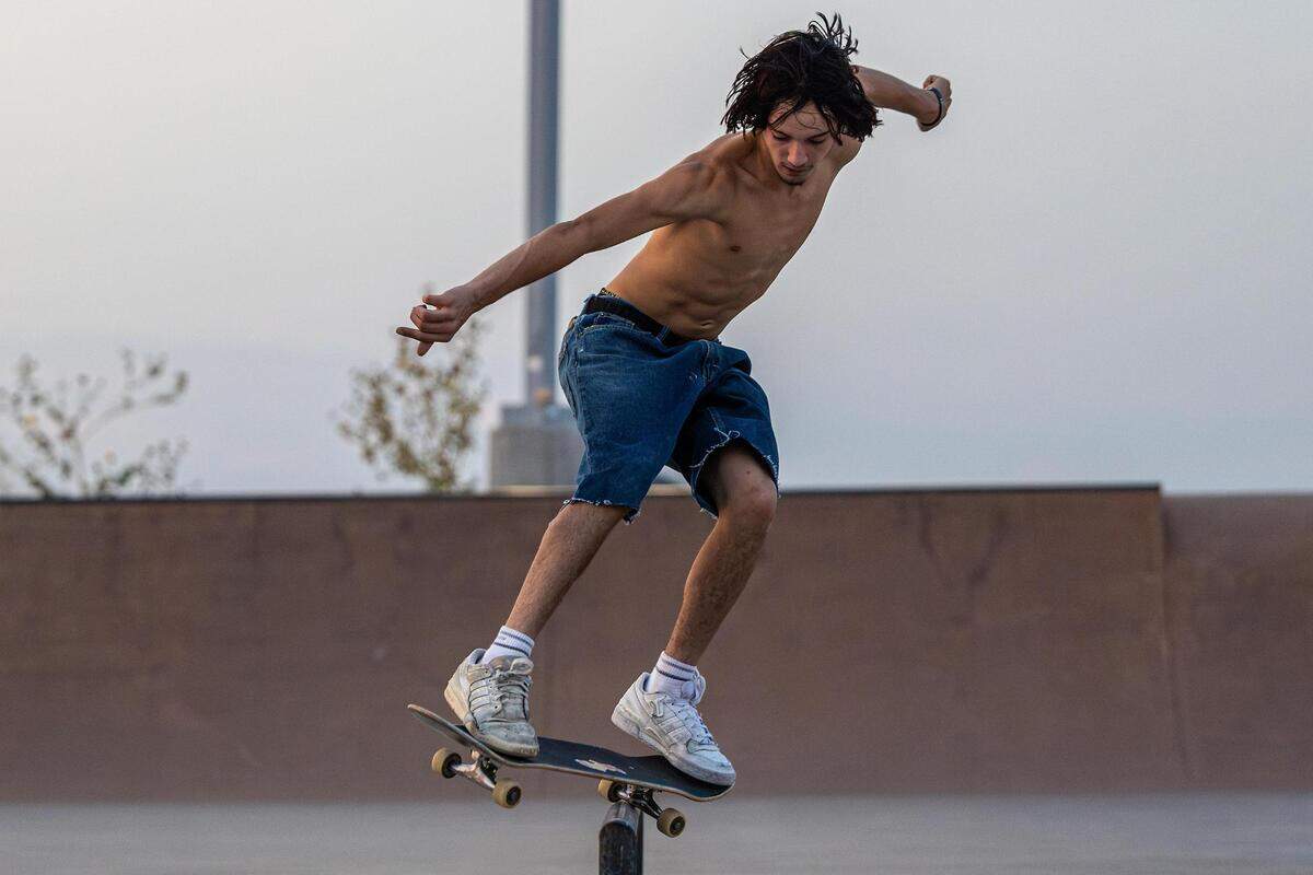 Ramsey Rivera skates on a railing at sunset at Chisholm Trail Skate Park in Fort Worth on Tuesday, Aug. 29, 2023.