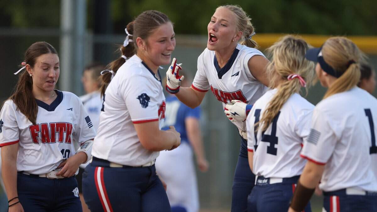 Grapevine Faith center fielder Michaela Hamilton celebrates with team mates after winning a softball game at Oak Grove Park in Grapevine, Tx. Tuesday, March 31, 2026