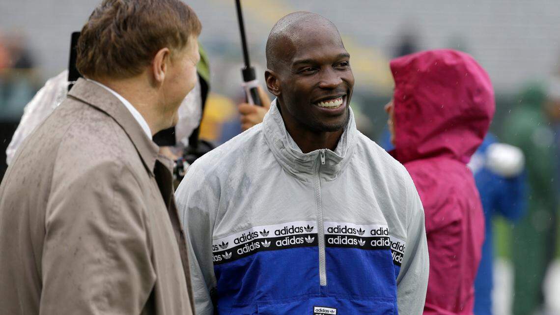 FILE - In this Sept. 22, 2019, file photo, former NFL football player player Chad Johnson, right, talks with Green Bay Packers president and chief executive officer Mark Murphy before the start of a game between the Denver Broncos and Green Bay Packers in Green Bay, Wis. (AP Photo/Mike Roemer, File)
